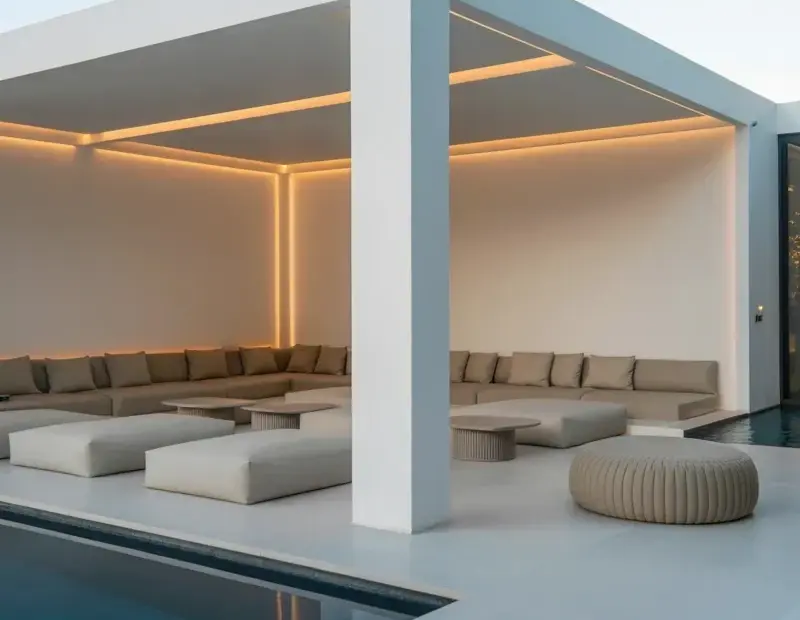 Budget backyard makeover: modern poolside lounge with minimalist white pavilion and infinity pool