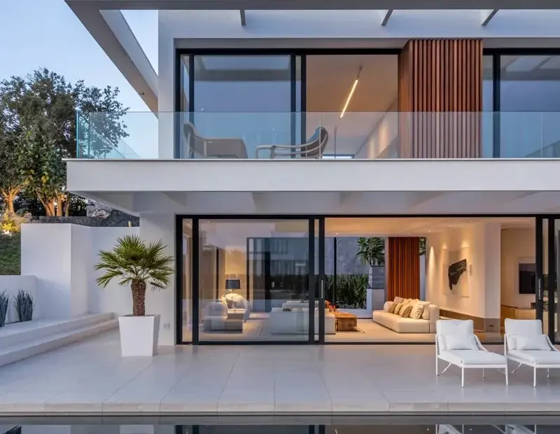 Modern villa design on a budget with infinity pool and glass walls